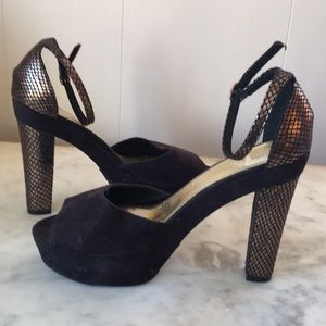 Black suede platforms with gold stacked heels.